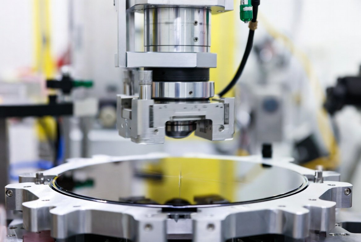 A robotic end-effector performing high-precision wafer handling in a semiconductor cleanroom.