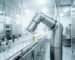 An automated food and beverage packaging line utilizing a sealed, stainless steel rotary actuator for wash-down processing.